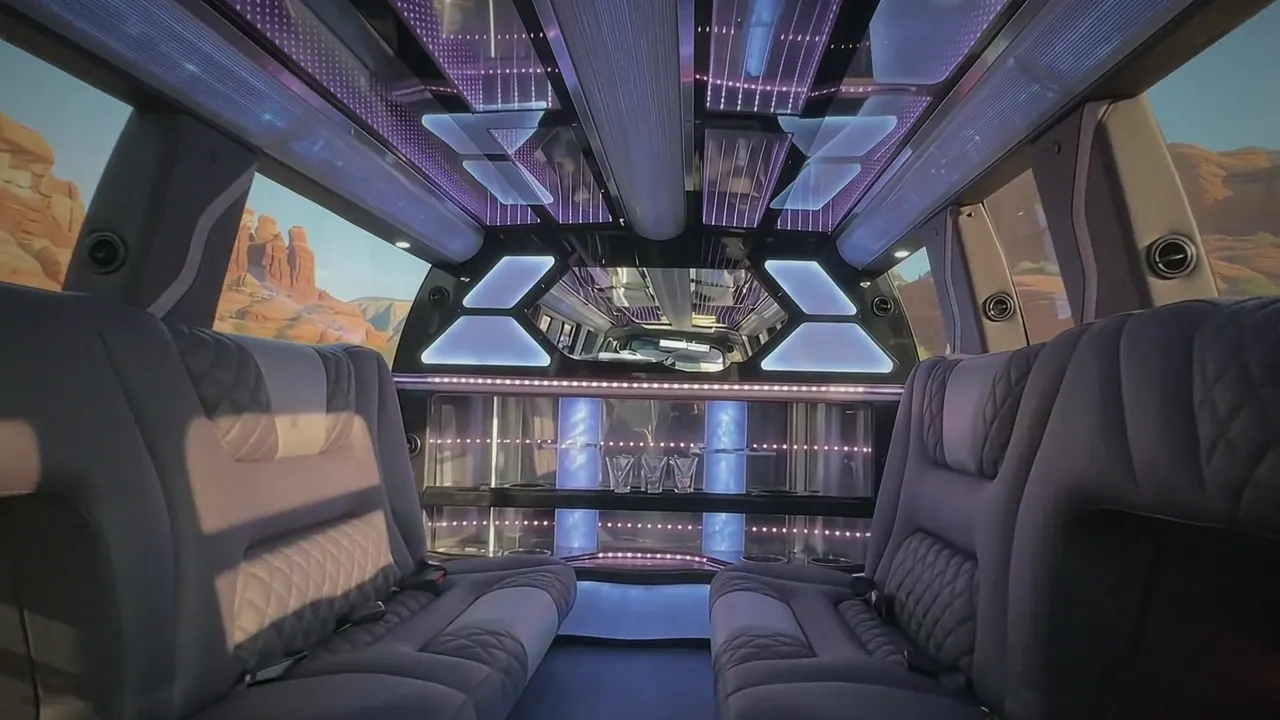 Inside the Cadillac Escalade limo in Laramie: LED light-show ceiling, leather lounge seating and lit bar